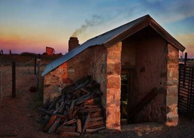 Bakery at dawn, oven stoked up and a pile of wood ready for the day ahead