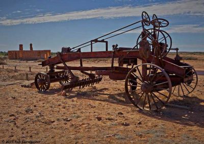 Camel drawn road grader with Post Office in the background