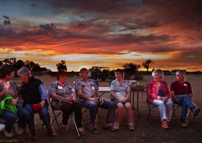 Sunset behind volunteers during the happy hour (and dinner)