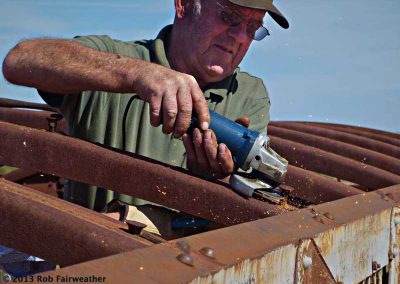 Cutting off old bolts after the rotten timber had been removed
