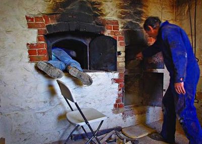 Dennis Benson in the oven, assisted by Doug MacLennan.