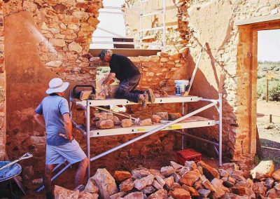 Stonemasons rebuilding wall Exchange Hotel