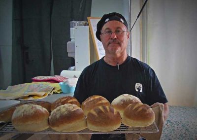 Jeremy with a tray of artisan bread.