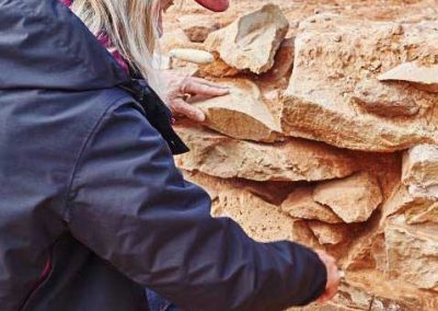 Cheryl cleaning out old mortar