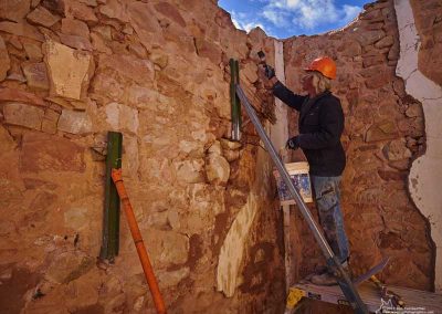Ron Johnson wetting down the rocks prior to adding pointing mortar