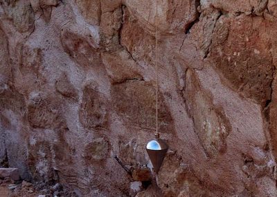 The plumb bob on the other side of the wall.