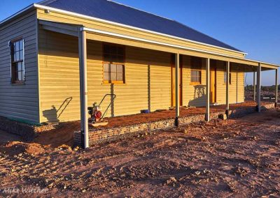 Tamping the back-filling behind the Gambions on the front of the building