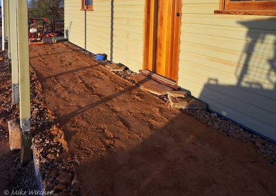 Tamping the back-filling behind the Gambions on the front of the building