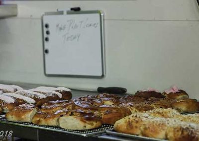 Freshly baked product being transferred to the cooling racks.