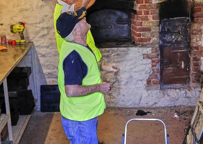 Reaching for a Peel (used to move product in and out of the oven)